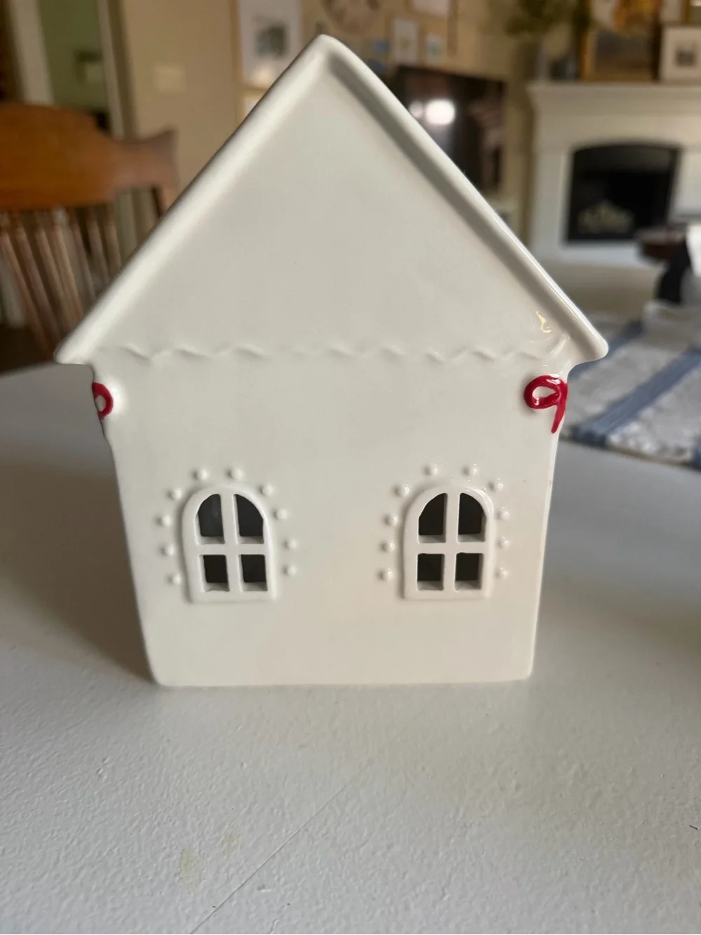 White Ceramic Holiday House with Green Garland and Red Bows